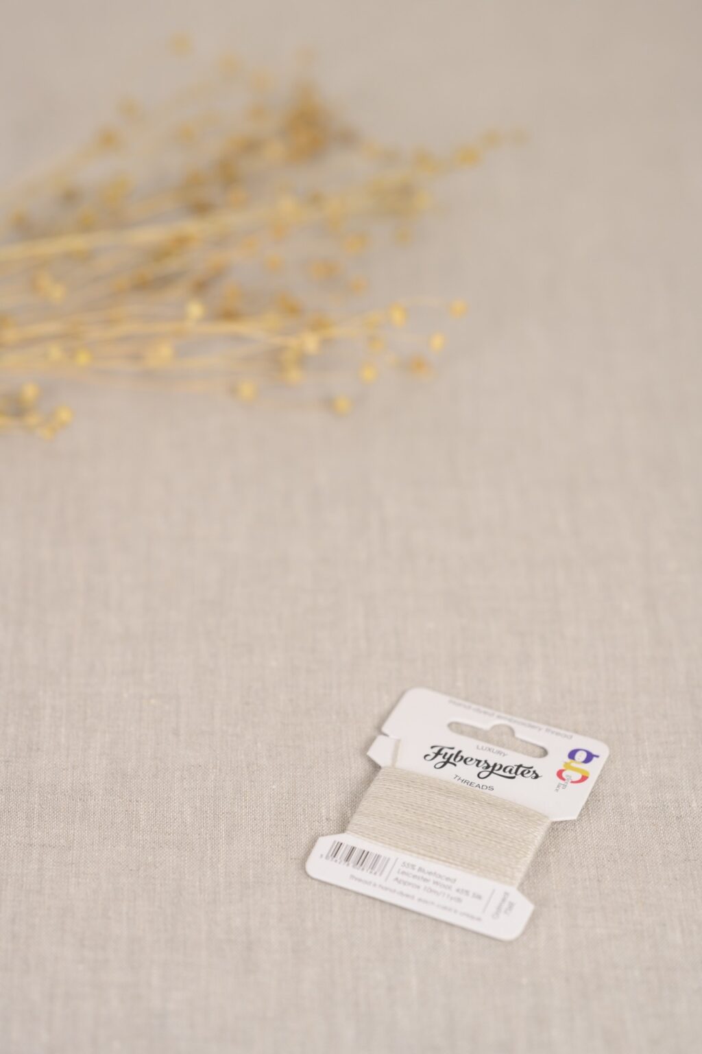 a close up of an oatmeal coloured thread