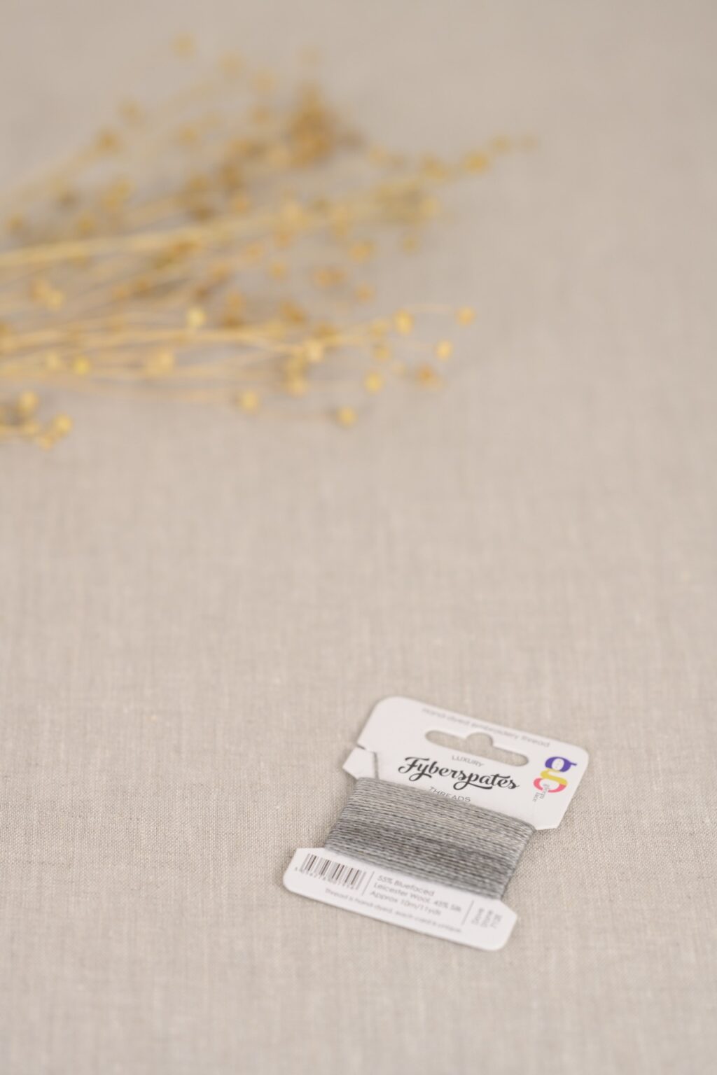 a close up of grey embroidery thread