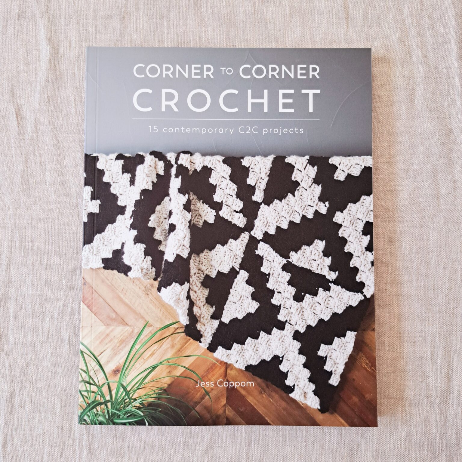 The book cover shows a black and white geometric Corner to Corner blanket